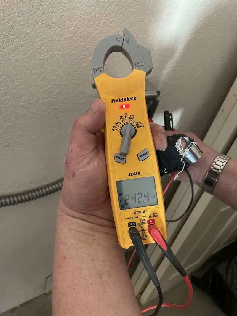 Voltage testing with clamp meter during Ceiling Fan Installation in Lakeville